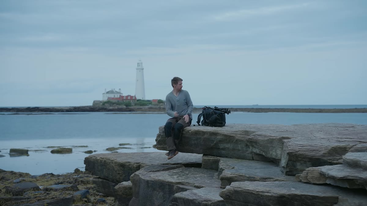 Photographer standing at coast after sunset, gear not yet out
