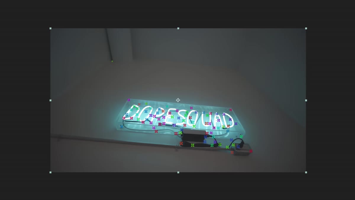 Composition panel showing colorful tracking dots spread across the footage