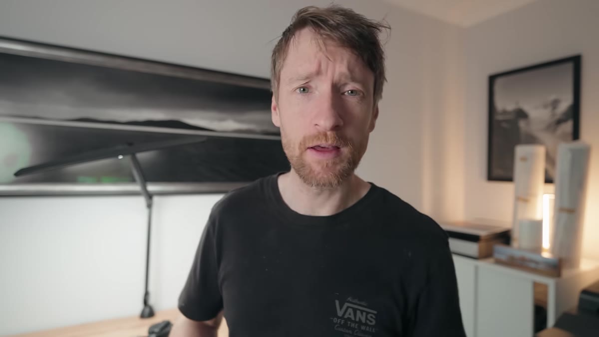 Heaton opening a photography guidebook to a random page
