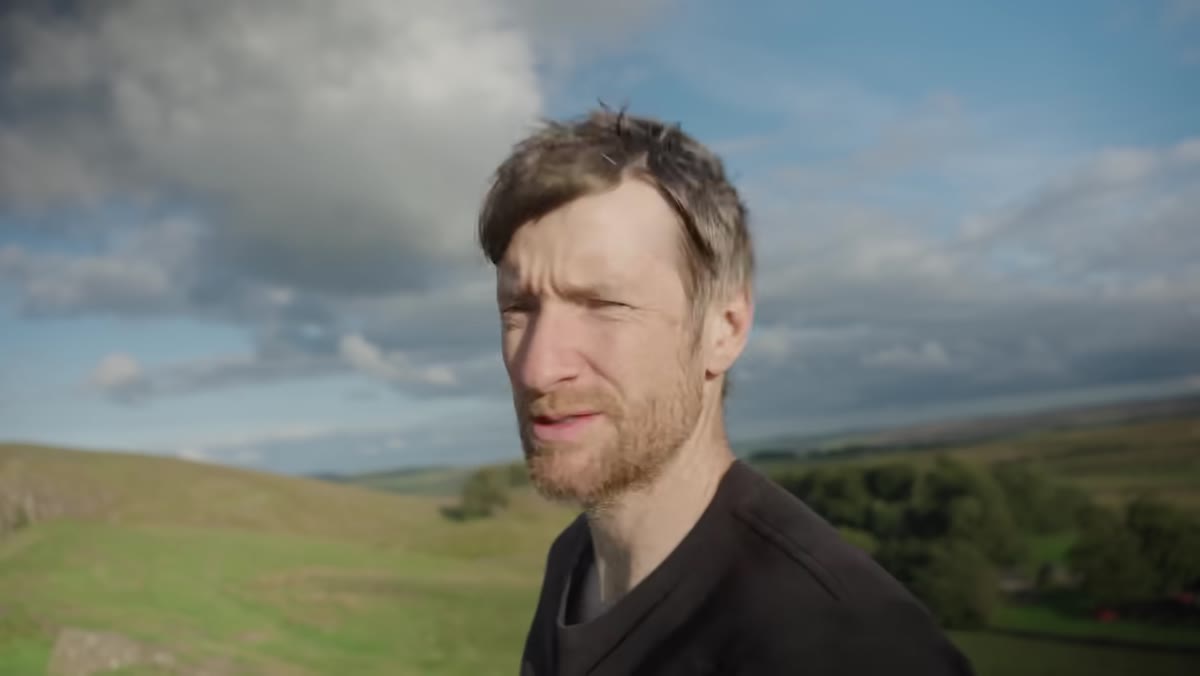 Heaton reviewing the high-contrast tree composition on camera screen