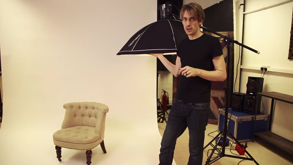 Sean Tucker holding Canon 5D Mark II beside lighting stand