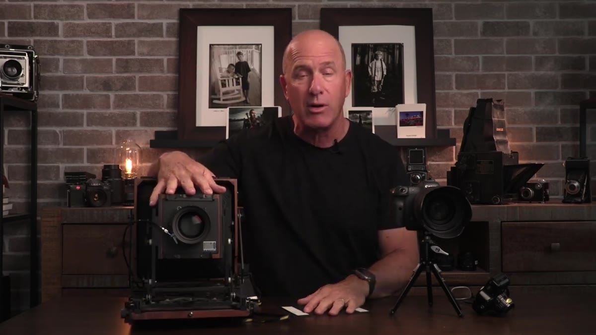 Joel holding a 4x5 view camera in studio