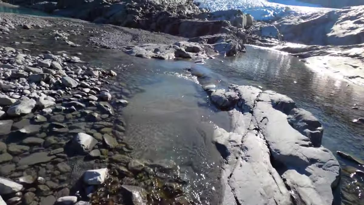 Terminal face of glacier visible after crossing rocky terrain