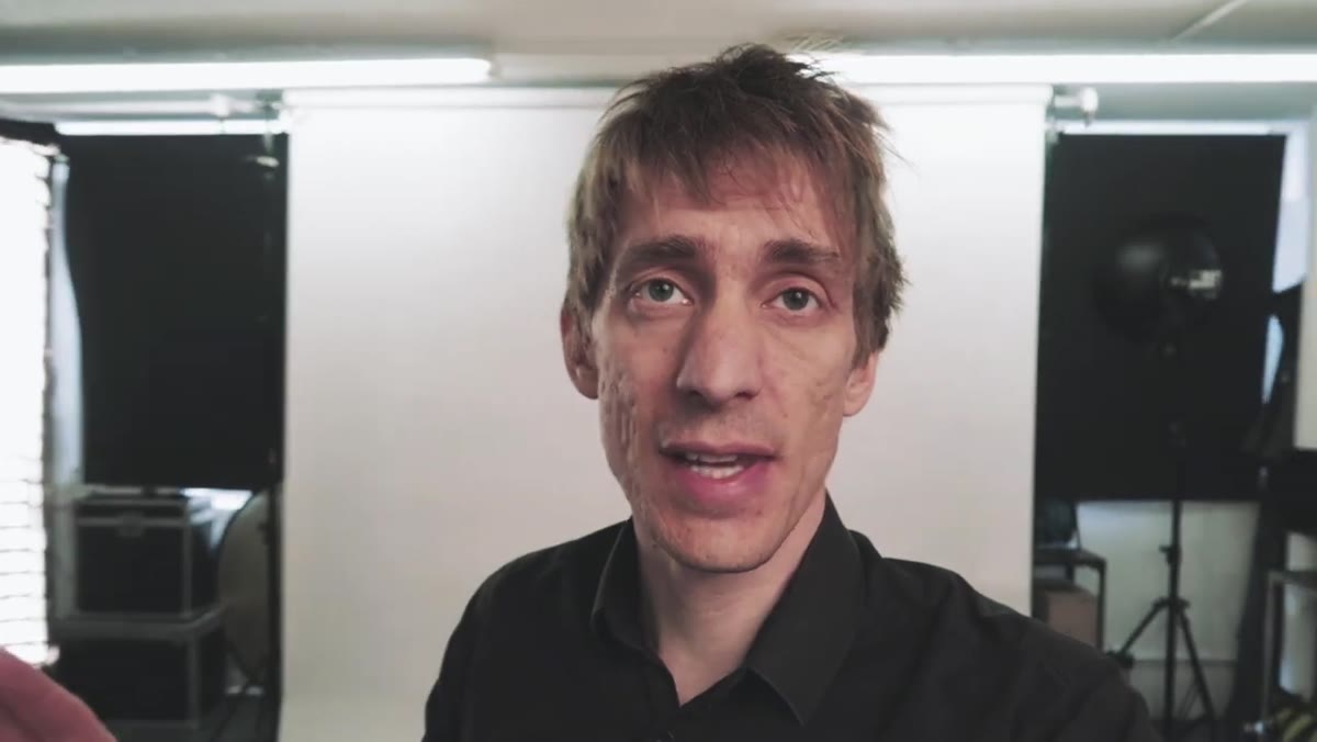 Sean Tucker standing in front of lit white paper backdrop