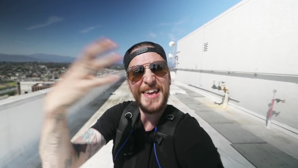 Vlogger squinting on a rooftop in bright LA midday sun