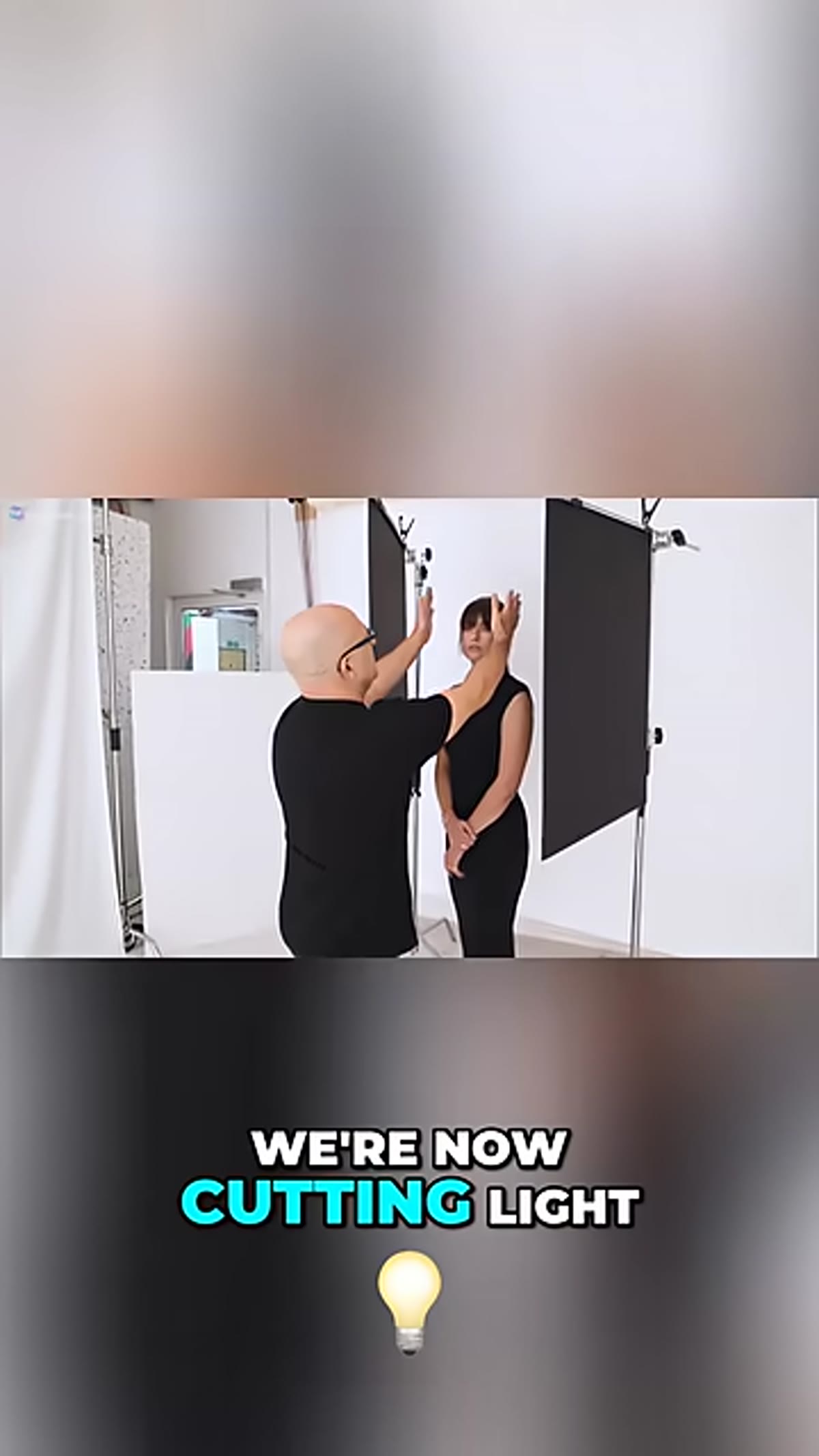 Black foam board being placed close to subject&rsquo;s face