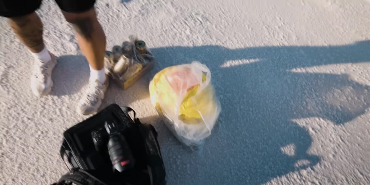 Parachute canopy laid out beside the car on salt flats