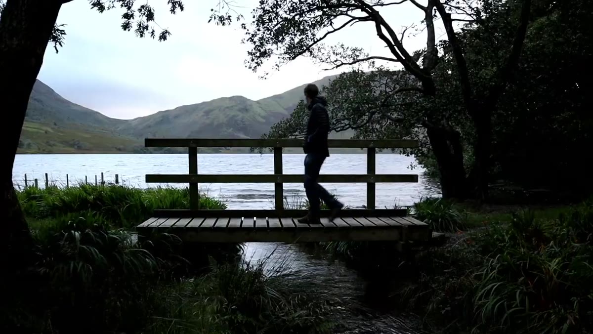 Thomas walking near the water&rsquo;s edge at Crummock Water