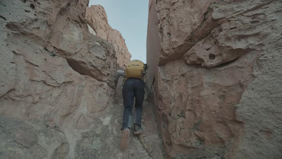 Thomas choosing to climb rocks rather than explore canyon floor