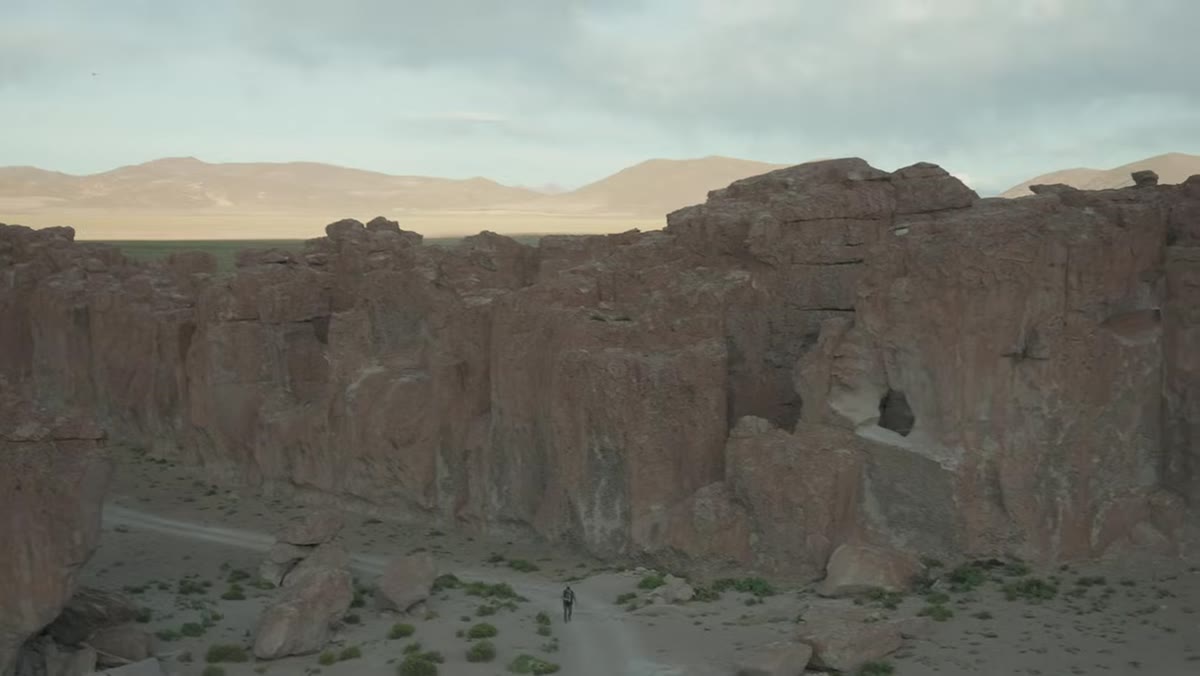 Thomas spotting distant mountains lighting up beyond the canyon rocks