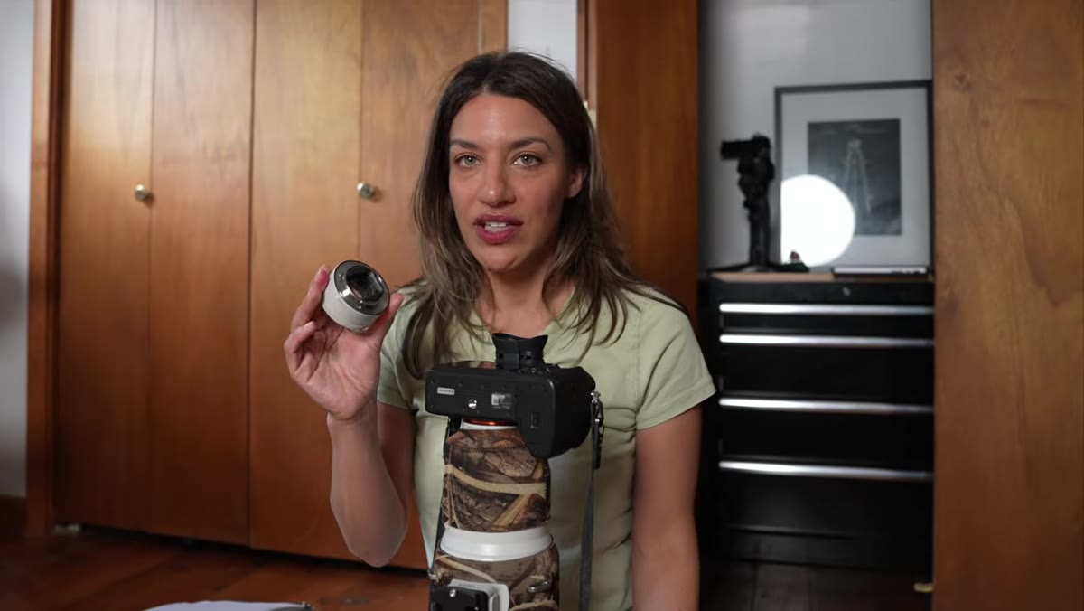 Chelsea holding 600mm lens and teleconverter side by side